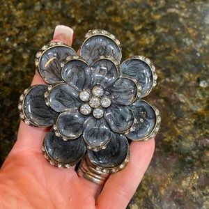 Flower-shaped, grey-pearl and silver belt buckle.